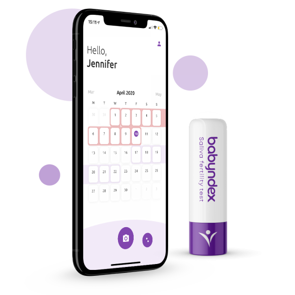Babyndex saliva ovulation microscope next to a phone showing the fertility app